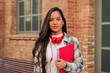 © Jose Calsina - Close up individual portrait of a pretty hispanic female student with serious expression looking at camera at high school. Head shot of latin teenage girl standing outdoors at the university campus