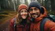 © Ashfaq - Happy couple hiking in the forest. Man and woman are smiling and looking at camera.