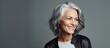 Confident Senior Woman in Stylish Black Jacket and Grey Hair Posing Outdoors