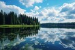 Serene body of water surrounded by trees and clouds, ideal for nature themes