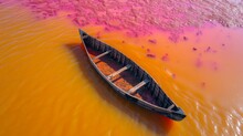  A Boat Floating On Top Of A Body Of Water With Orange And Pink Dye On The Bottom Of The Water.