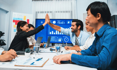 Wall Mural - Analyst team leader celebrate and high five together with his colleague after successful data analysis meeting using FIntech software power with business intelligence or BI dashboard. Prudent