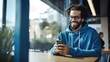 © MP Studio - Smiling man in blue clothes is using the phone