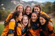 Group of young women soccer players rejoicing and celebrating a successful win on the field