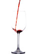 Red wine is poured into an isolated glass on a transparent background