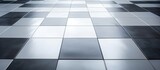 Fototapeta  - The flooring in the building features a black and white checkered pattern resembling a chess board. The rectangular tiles create a sense of parallel symmetry with varying tints and shades of grey