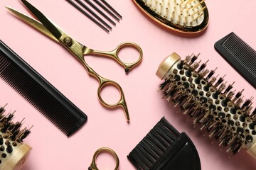 Wall Mural - Professional hair dresser tools on pink background, flat lay