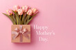 Pink flat layout with gift and bouquet of tulips for Mother's Day conceptual banner