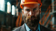 A man with a beard wearing a hard hat. Suitable for construction and industrial concepts