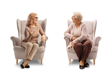 Canvas Print - Elderly mother and daughter sitting armchairs and talking