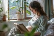 An expectant mother enjoys a peaceful moment reading by a window with plants and warm sunlight