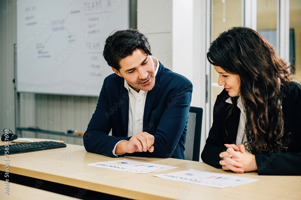 Two colleagues in an office meeting, collaborating and planning their ...