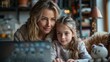 © TheGoldTiger - Woman and a young girl are looking at a laptop screen together in a cozy room