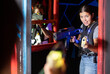 © JackF - Young woman playing lasertag in arena