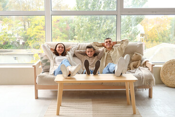 Sticker - Little boy with his parents resting on couch at home