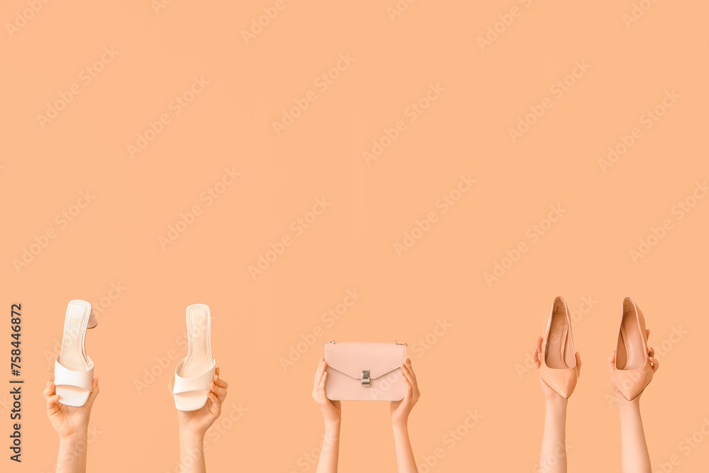 Women with stylish shoes and bag on beige background