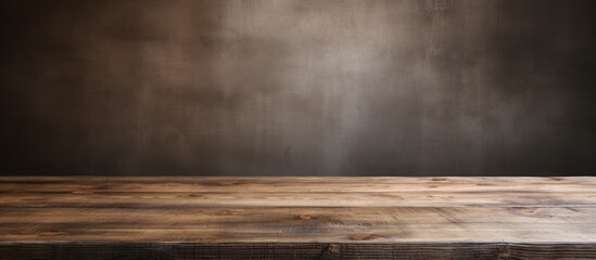 Wall Mural - A brown hardwood table is set against a dark natural landscape wall, highlighting the tints and shades of wood. The wood stain adds depth to the cloudfilled horizon