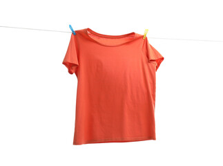 One orange t-shirt drying on washing line isolated on white