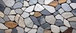 A detailed shot of a stone wall showcasing a mix of colored rocks. The variation in colors creates a beautiful pattern, ideal for landscaping or as a building material