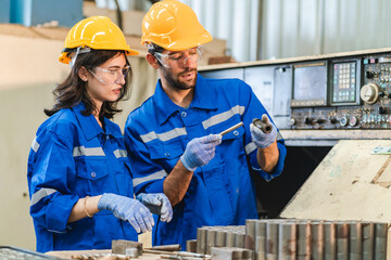 Wall Mural - professional business industry technician wearing safety helmet working to maintenance service and checking factory equipment, a work of engineer occupation in manufacturing construction technology