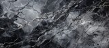 Fototapeta  - A detailed shot of a black and white marble texture resembling a natural landscape with elements of bedrock, soil, and darkness, captured in monochrome photography
