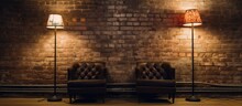 Two Wooden Chairs And Two Vintage Lamps Stand In Front Of A Rustic Brick Wall In A Charming Setting