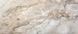 A close up of a beige marble surface resembling a rock outcrop. The smooth texture contrasts with the roughness of limestone, creating a stunning landscape