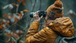 A woman is capturing a wildlife event by photographing a tree with her camera