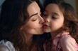 © vefimov - Woman is kissing little girl on cheek