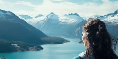 Poster - Woman is looking out over beautiful mountain range and lake