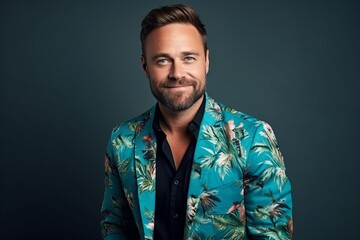 Wall Mural - Portrait of a handsome man in a turquoise jacket.