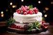 Layered cake decorated with berries, raspberries on top and fresh leaves, pine cones decoration on bokeh background for Christmas season or Birthday