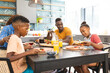 © Wavebreak Media - An African American family enjoys a breakfast together at home, diverse group