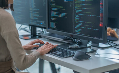 Wall Mural - close up hand of asian prompt engineer developer coding app with software data sitting in front of c