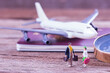 Miniature people traveler standing on the floor and airplane