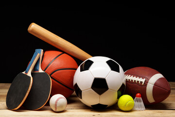 Wall Mural - Various sports equipment on black background studio shot