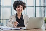 Fototapeta Łazienka - Portrait of Young Successful Caucasian Businesswoman Sitting at Desk Working on Laptop