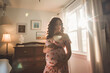 maternity photo with young pregnant Hispanic woman