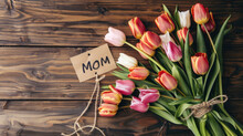 Greeting Card, Banner, Bouquet Of Tulips On The Table With The Text "Mom". Copy Space. Mother's Day, Birthday, Anniversary, March 8
