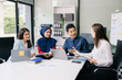 © Nuttapong punna - Multiracial group of young creative people in smart casual wear discussing business brainstorming meeting ideas design project.