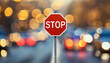 Stop road sign. Red octagon with white lettering. Blurred bokeh on background.