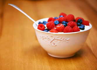 Sticker - Wood, berries and bowl with yogurt, raspberry and blueberry for organic snack. Food, cuisine and breakfast for health, wellness and diet for morning nutrition and antioxidant wellbeing in studio