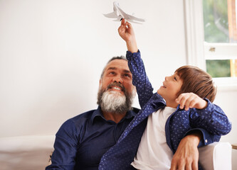 Wall Mural - Grandpa, kid and playing with toy airplane in home, love and bonding together on vacation in living room. Happy family, boy and grandfather with jet game in lounge, relax and care on school holiday