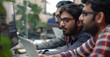 © GustavsMD - Software Indian Developers Working Together. Colleagues collaborating on a project with a computer monitor