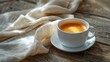 Coffee cup on the wooden table with white linen napkin