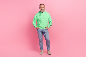 Wall Mural - Full body photo of nice retired male hands pockets jeans model shopping dressed stylish green outfit isolated on pink color background