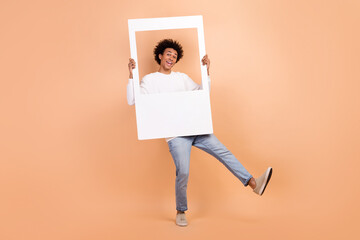 Poster - Full length photo of positive optimistic guy wear trendy clothes dance hold photography isolated on beige color background