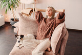 Fototapeta Zwierzęta - Happy middle aged Woman relaxing at home