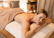 Spa for women, concept. Cute woman enjoying rest and massage at wellness center