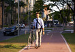 © MV/peopleimages.com - Bicycle, city and portrait of happy businessman for travel, morning commute and walking to work. Professional, urban town and person with bike for cycling, sustainable and eco friendly transport